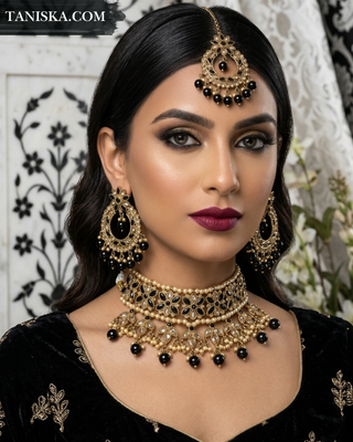 Luxury black and gold Kundan bridal necklace set featuring intricate floral detailing with matching earrings and maang tikka, an elegant statement piece for South Asian weddings and formal occasions