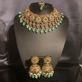 Luxury mint green Kundan bridal necklace set with matching jhumka earrings and maang tikka, elegant statement jewelry for South Asian weddings and nikah ceremonies.