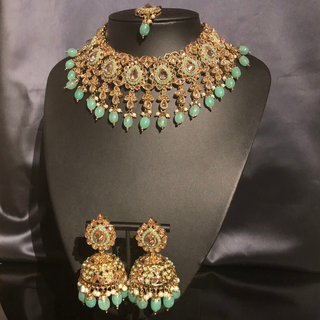 Luxury mint green Kundan bridal necklace set with matching jhumka earrings and maang tikka, elegant statement jewelry for South Asian weddings and nikah ceremonies.