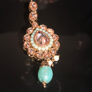 Luxury mint green Kundan bridal necklace set with matching jhumka earrings and maang tikka, elegant statement jewelry for South Asian weddings and nikah ceremonies.