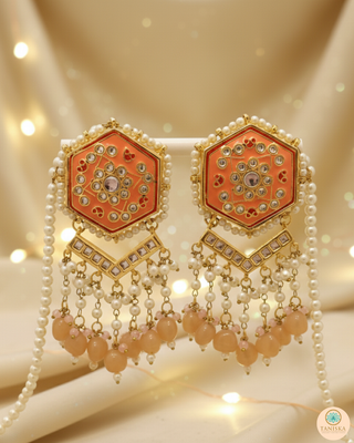 Luxury peach-orange meenakari Kundan choker necklace set with matching jhumka earrings and maang tikka, vibrant statement jewelry for South Asian bridal weddings and festive occasions.