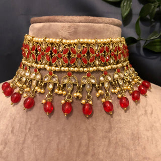 Luxury red and gold Kundan bridal necklace set with matching earrings and maang tikka, statement jewelry for South Asian weddings and nikah ceremonies.