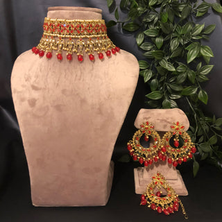 Luxury red and gold Kundan bridal necklace set with matching earrings and maang tikka, statement jewelry for South Asian weddings and nikah ceremonies.