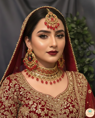 Luxury red and gold Kundan bridal necklace set with matching earrings and maang tikka, statement jewelry for South Asian weddings and nikah ceremonies.