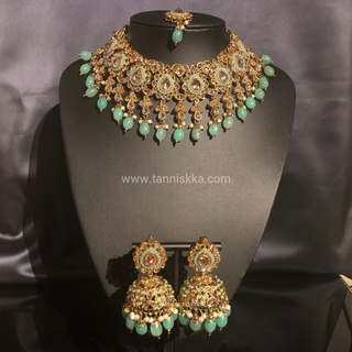 Luxury mint green Kundan bridal necklace set with matching jhumka earrings and maang tikka, elegant statement jewelry for South Asian weddings and nikah ceremonies.
