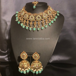 Luxury mint green Kundan bridal necklace set with matching jhumka earrings and maang tikka, elegant statement jewelry for South Asian weddings and nikah ceremonies.