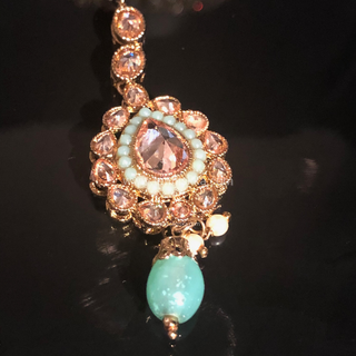 Luxury mint green Kundan bridal necklace set with matching jhumka earrings and maang tikka, elegant statement jewelry for South Asian weddings and nikah ceremonies.