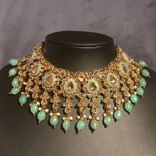 Luxury mint green Kundan bridal necklace set with matching jhumka earrings and maang tikka, elegant statement jewelry for South Asian weddings and nikah ceremonies.