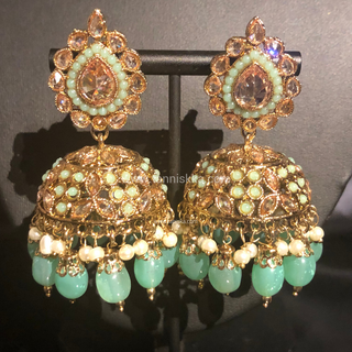 Luxury mint green Kundan bridal necklace set with matching jhumka earrings and maang tikka, elegant statement jewelry for South Asian weddings and nikah ceremonies.